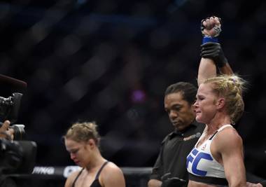Holly Holm, right, celebrates after defeating Ronda Rousey, left, during their UFC 193 Bantamweight title fight Sunday in Melbourne,&nbsp;Australia.