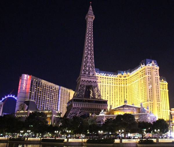 Hotel Paris and Replica of Eiffel Tower at Night in Las Vegas