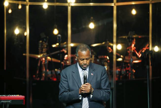 Republican presidential candidate Dr. Ben Carson prays before speaking Sunday, Nov. 15, 2015, at the International Church of Las Vegas. Carson spoke at the church ahead of a scheduled rally in Henderson.