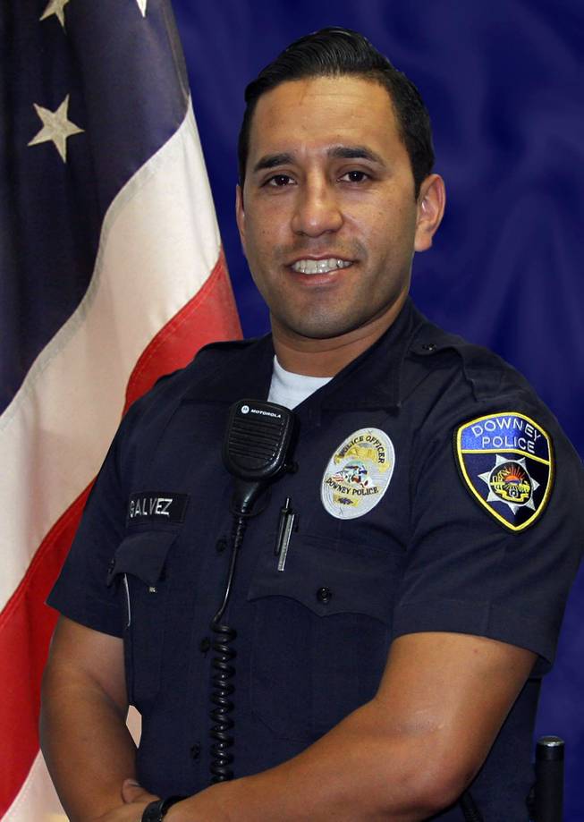 In this undated photo released the Downey Police Department shows Downey police officer Ricardo Galvez, 29. He was shot to death in the driver's seat of his personal vehicle when two male suspects ran up and opened fire late Wednesday, Nov. 18, 2015, in the parking lot of Downey police headquarters in Downey, Calif. 
