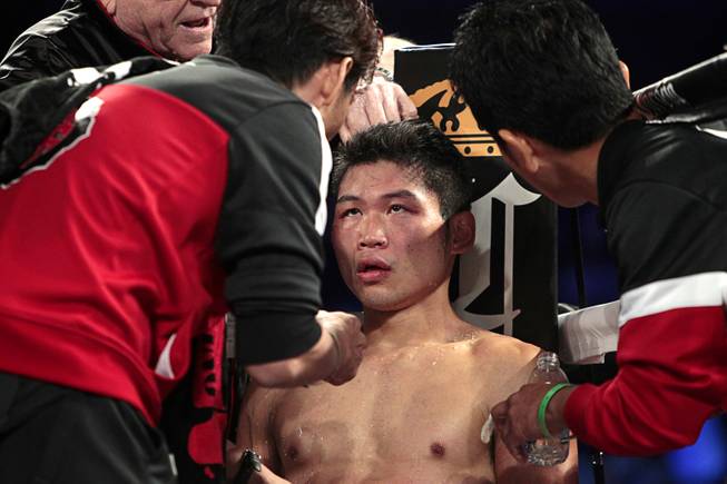 WBC super featherweight champion Takashi Miura of Japan is treated in his corner between rounds during his title defense against Francisco Vargas of Mexico at the Mandalay Bay Events Center Saturday, Nov. 21, 2015.