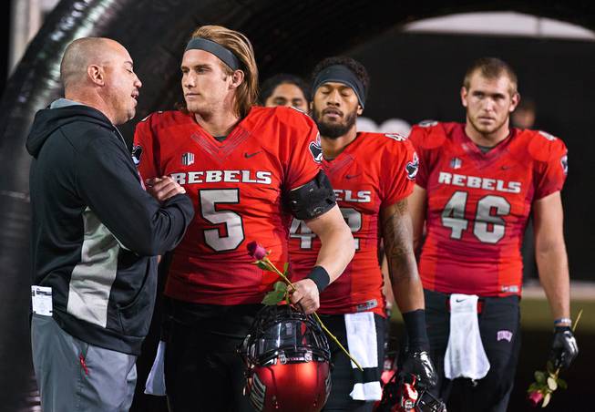 UNLV head coach Tony Sanchez has kind words for senior QB Blake Decker (5)and others on "senior night" as they face San Diego State in their game at Sam Boyd Stadium on Friday, November 21, 2015.