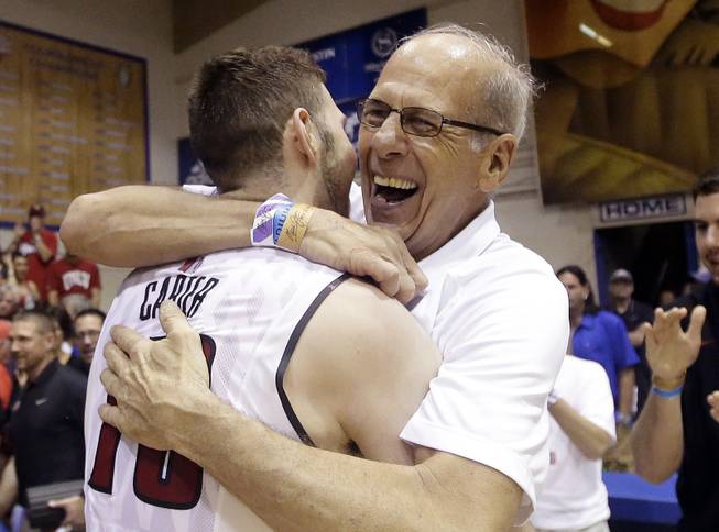 UNLV forward Ben Carter celebrates with his father, Mike Carter, after defeating Indiana in the Maui Invitational on Wednesday, Nov. 25, 2015, in Lahaina, Hawaii. UNLV won 72-69. 