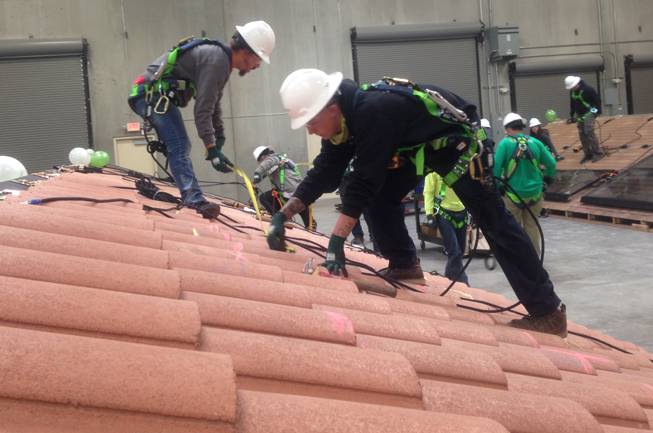 SolarCity workers practice installing solar panels at the company's new facility in Las Vegas.


