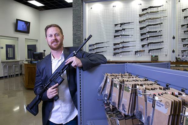 Brian Doleshal, general manager for The Range 702, poses with a Heckler & Koch MR556A1 assault rifle at the shooting range at 5999 Dean Martin Dr. Tuesday, Dec. 1, 2015.