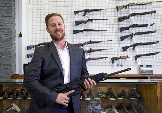Brian Doleshal, general manager for The Range 702, poses with a Heckler & Koch MR556A1 assault rifle at the shooting range at 5999 Dean Martin Dr. Tuesday, Dec. 1, 2015.