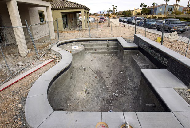 A backyard pool at a model home is shown under construction at The Estates at Rhodes Ranch, a Century Communities development, Thursday, Dec. 3, 2015.