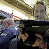 Trader Gregory Rowe works on the floor of the New York Stock Exchange on Friday, Dec. 4, 2015. Stocks are posting solid gains Friday morning after the U.S. government reported another month of strong job gains. 