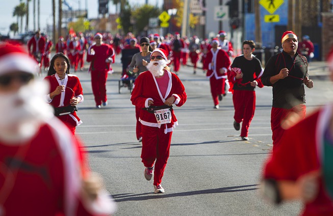 People dressed as Santa Claus run in the 11th annual ...