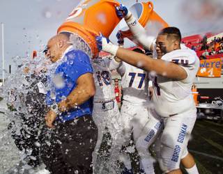 Bishop Gorman head coach Kenneth Sanchez is drenched with iced water by his players after defeating Liberty 62-21 in their Division 1 State Football Championship game at Sam Boyd Stadium on Saturday, December 5, 2015.