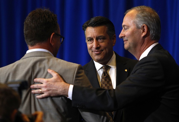 Nevada Governor Brian Sandoval, center, Dag Reckhorn, left, global vice president of manufacturing for Faraday Future, and Steve Hill, director of the Governors Office of Economic Development, are shown during a news conference at the Sawyer State Building in Las Vegas Thursday, Dec. 10, 2015.