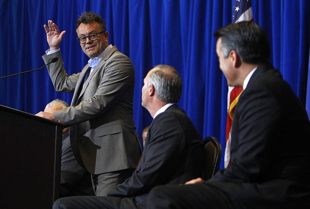 Dag Reckhorn, left, global vice president of manufacturing for Faraday Future, looks toward Steve Hill, center, director of the Governors Office of Economic Development, and Nevada Governor Brian Sandoval, as he speaks during a news conference at the Sawyer State Building in Las Vegas Thursday, Dec. 10, 2015.