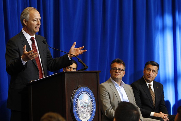 Steve Hill, left, director of the Governors Office of Economic Development, speaks during a news conference as Dag Reckhorn, global vice president of manufacturing for Faraday Future, and Nevada Governor Brian Sandoval look on at the Sawyer State Building in Las Vegas Thursday, Dec. 10, 2015.