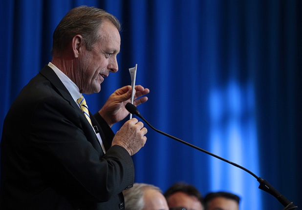 North Las Vegas Mayor John Lee holds up a newspaper with front page coverage of the Faraday Future factory plans during a news conference at the Sawyer State Building in Las Vegas Thursday, Dec. 10, 2015. Officials at the news conference discussed plans from electric-car startup Faraday Future to build its $1 billion factory in the city of North Las Vegas.