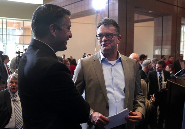 Nevada Governor Brian Sandoval, left, speaks with Dag Reckhorn, global vice president of manufacturing for Faraday Future, following a news conference at the Sawyer State Building in Las Vegas Thursday, Dec. 10, 2015. Officials discussed Faraday Future's plans to open its $1 billion factory in the city of North Las Vegas.