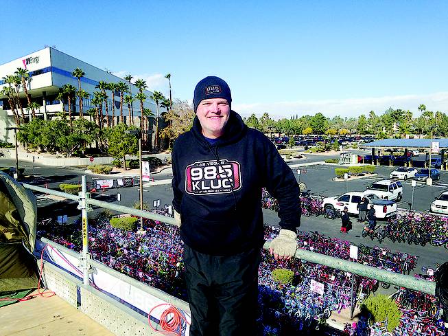 Chet Buchanan poses in front of a sea of about 2,800 bicycles from his KLUC-FM 98.5 Toy Drive perch at NV Energy on West Sahara Avenue, just west of Jones Boulevard, on Friday, Dec. 12 2015.