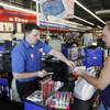 In this July 6, 2011 photo, Pep Boys Auto retail sales manager Matt Myers hands costumer Michael Simmons of Philadelphia his change at a Pep Boys Auto retail and service location, in Philadelphia. 