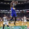 Golden State Warriors forward Andre Iguodala (9) slams a dunk over Boston Celtics guard James Young (13) during the first quarter of an NBA basketball game in Boston, Friday, Dec. 11, 2015. 