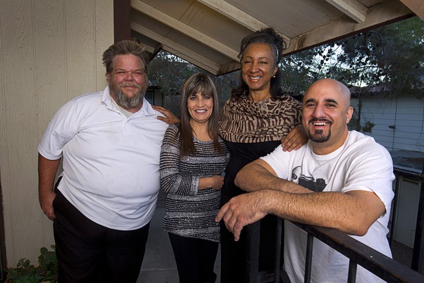Natalie Perry, second right, poses with her neighbors at her apartment Sunday Dec. 13, 2015. Her neighbors came to her rescue during a kitchen fire on Halloween. From left are: Don Mumma, Rocio Mendez, and Nick Berbari.
