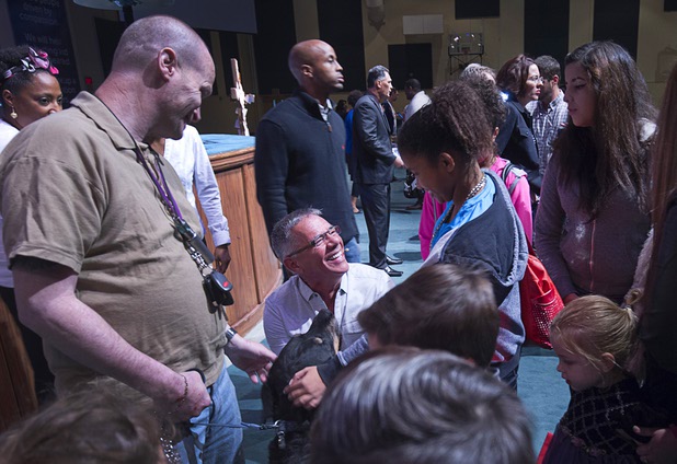 Pastor Paul Goulet pets a church member's service dog after a service at the International Church of Las Vegas, 8100 Westcliff Drive, Sunday Dec. 13, 2015.