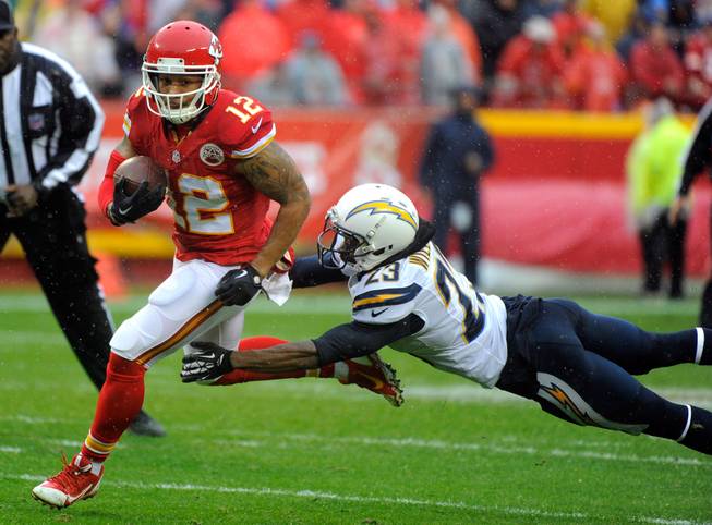 Kansas City Chiefs wide receiver Albert Wilson, left, gets past a tackle attempt by San Diego Chargers cornerback Steve Williams while running for a touchdown Sunday, Dec. 13, 2015, during the first half of an NFL football game in Kansas City, Mo.