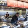 A Chipotle Mexican Grill employee prepares food on Tuesday Dec. 15, 2015, in Seattle. Chipotle founder and CEO Steve Ells was visiting restaurants in the Pacific to discuss new food safety protocols with employees after an E. coli outbreak sickened 50 people in the Northwest. 