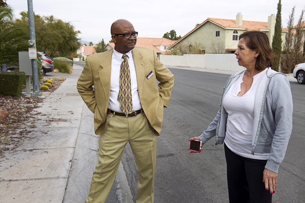 Neighbors Flemming Moses, left, and Yvonne Karim talk in front of a house that was occupied by squatters in the northwest part of the valley Dec. 9, 2015. The neighbors said the occupants of a squatter house threw a Halloween party that got out of hand and ended in an early morning shooting.