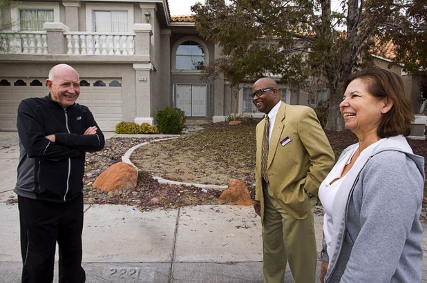 Neighbors Jeff Raithel, left, Flemming Moses, center, and Yvonne Karim talk in front of a house that was occupied by squatters in the northwest part of the valley Dec. 9, 2015. The neighbors said the occupants of a squatter house threw a Halloween party that got out of hand and ended in an early morning shooting.