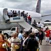 In this Nov. 1, 2001, file photo, the first passengers of the first flight of Continental Airlines from Miami arrive at Jose Marti Airport in Havana, Cuba. The United States and Cuba have reached an understanding on restoring regularly scheduled commercial flights, Cuban and U.S. officials said Wednesday, Dec. 16, 2015, on the eve of the anniversary of detente between the Cold War foes.
