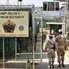 In this June 27, 2006 file photo, reviewed by a U.S. Department of Defense official, U.S. military guards walk within Camp Delta military-run prison, at the Guantanamo Bay U.S. Naval Base, Cuba. 