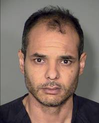 This booking photo released by Metro Police shows Teag Fox. Authorities are identifying Fox as the man suspected of shooting an officer and then eluding police in Las Vegas before being arrested in a golf course community miles away.