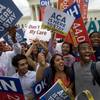 In this June 25, 2015, file photo, students cheer as they hold up signs, outside of the Supreme Court in Washington, supporting the Affordable Care Act after the Supreme Court decided that the ACA may provide nationwide tax subsidies. Republican foes of President Barack Obama’s health care law may be able to get more by chipping away at it than trying to take the whole thing down at once. That’s the lesson of the budget deal passed by Congress and signed by the president on Dec. 18. It delayed a widely-criticized tax on high-cost employer health insurance plans that hasn’t taken effect yet. And it temporarily suspended two taxes on industry already being collected, which are also part of the health law. 