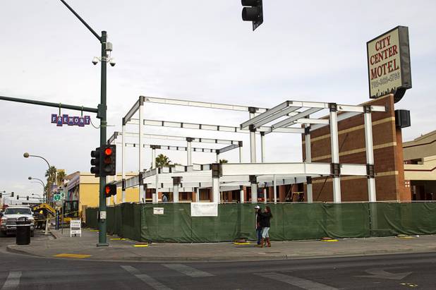 Pedestrians pass by a two-story Indian restaurant under construction on the northeast corner of Fremont and Seventh streets at the City Center Motel in downtown Las Vegas Monday, Dec. 21, 2015.
