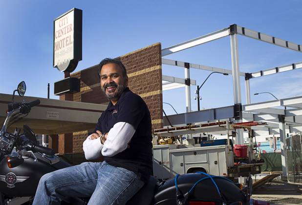Owner Rajesh Patel poses in front of the City Center Motel, where an Indian restaurant is under construction at Fremont and Seventh streets, Wednesday, Dec. 23, 2015. The 6,000-square-foot restaurant, including an outdoor second-floor dining area, is expected to open in the summer of 2016, he said.