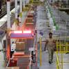 A worker walks near a high-speed scanning conveyor belt at Amazon.com's fulfillment center in DuPont, Wash. Amazon Prime, the company’s $99-a-year loyalty program that includes unlimited free two-day shipping, gained 3 million new members in the third week of December.