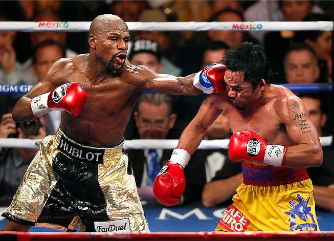 Floyd Mayweather connects to the chin of Manny Pacquiao during their fight Saturday, May 2, 2015, at MGM Grand Garden Arena.