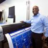 John Pinnington, owner of AA Printing Service, poses by a 54-inch large format printer at his shop at 4800 S. Maryland Parkway Wednesday, Dec. 30, 2015.