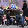 Visitors to New York's Times Square walk past the Toys R Us store, Wednesday, Dec. 30, 2015. 