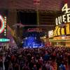 People listen to Pyromania at the Third Street Stage during New Year's Eve celebrations at the Fremont Street Experience Thursday, Dec. 31, 2015.