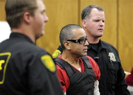  In this Nov. 17, 2011 file photo, Vagos motorcycle gang member Ernesto Gonzalez is led from district court under heavy security in Reno, Nev., after pleading guilty in the shooting death of Hells Angels member Jeffrey "Jethrow" Pettigrew. The Nevada Supreme Court has ordered a new trial for Gonzalez, convicted in a 2011 shootout between rival motorcycle clubs at a Reno-area casino.