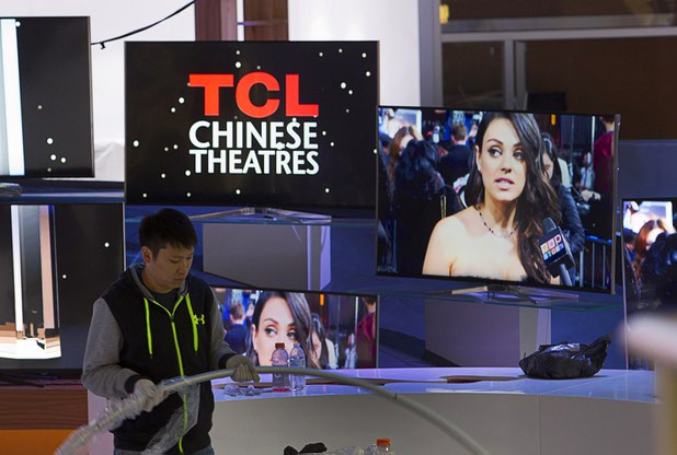 A worker sets up a display in the TCL booth in preparation for the 2016 International CES at the Las Vegas Convention Center Sunday, Jan. 3, 2016. The trade show floor opens on Jan. 6.