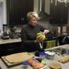 Gabrielle Novacek, a management consultant and frequent business traveler for the Boston Consultant Group holds a bundle of bananas as she prepares her meal for her upcoming flight to New York City at her home in Chicago, Jan. 4, 2016. The alternatives for those who travel frequently on business can include taking food from home or shopping just before a flight. 