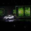 General Motors CEO Mary Barra stands next to the Chevrolet Bolt EV electric car at CES International Wednesday, Jan. 6, 2016, in Las Vegas. The 200-mile range electric car was introduced Wednesday.