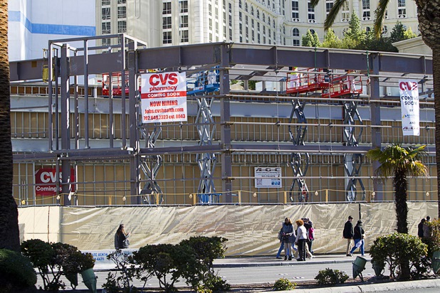 Pedestrians pass by a CVS pharmacy construction site on the Las Vegas Strip between Bally's and Paris Las Vegas Monday, Jan 11, 2016.