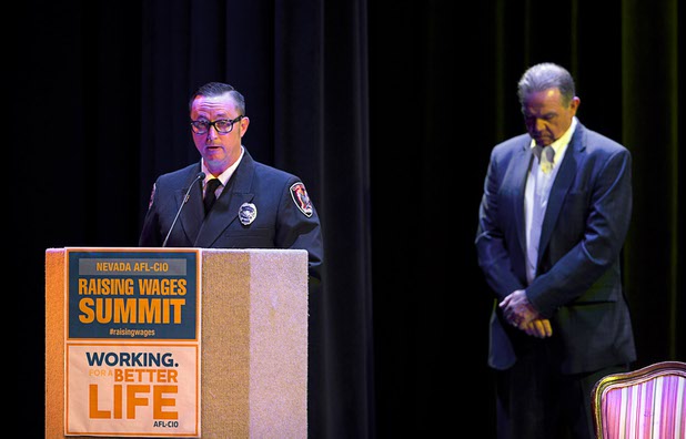 Michael Courtney, left, a Clark County Fire engineer, gives an invocation at the start of a Nevada AFL/CIO Raising Wages Summit at the College of Southern Nevada, Cheyenne Campus, Tuesday, Jan 12, 2016. Danny Thompson, executive secretary-treasurer of the Nevada AFL/CIO, stands by at right. STEVE MARCUS