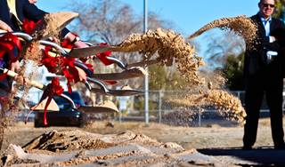 Dirt goes flying during a groundbreaking as a developer is finally breaking ground on a new retail/parking center across from UNLV which will be the site of a new parking garage, headquarters for UNLV's police force as well as some space for shops on Tuesday, January 12, 2016.