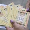 A woman shows Powerball tickets she purchased Tuesday, Jan. 12, 2016, in San Lorenzo, Calif.