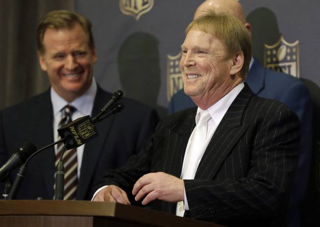 NFL Commissioner Roger Goodell, left, laughs as Oakland Raiders owner Mark Davis talks to the media after an NFL owners meeting Tuesday, Jan. 12, 2016, in Houston.