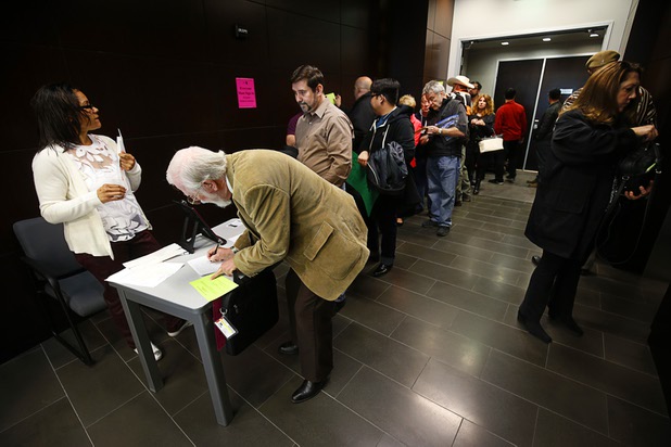 People line up to enter a Public Utilities Commission meeting Wednesday, Jan 13, 2016.
