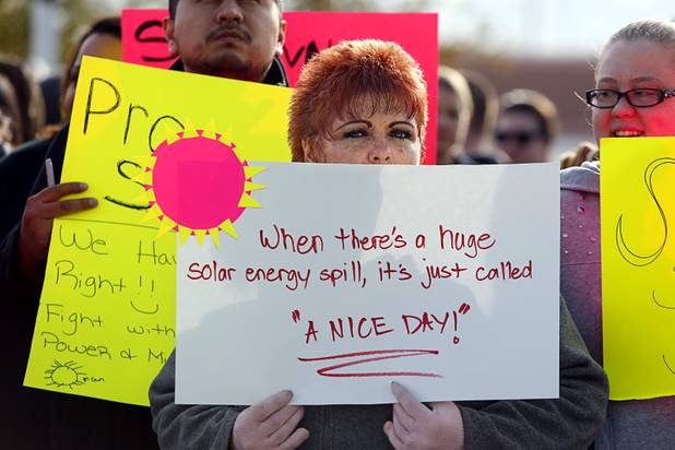 Pamela Lovato and other solar supporters rally in front of Public Utilities Commission offices Wednesday, Jan 13, 2016.